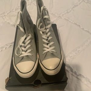 Grey leather men’s high top converse sneakers.